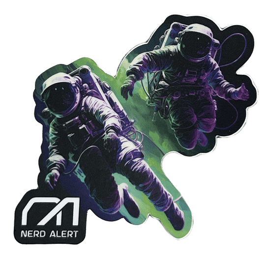 Two spacemen floating in front of a green and purple galaxy with the Nerd Alert logo in the bottom left corner.