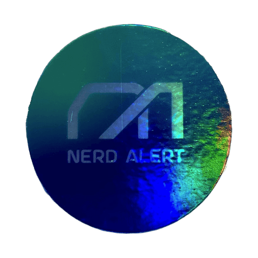 A round rainbow holographic sticker with the Nerd Alert logo as the primary design.